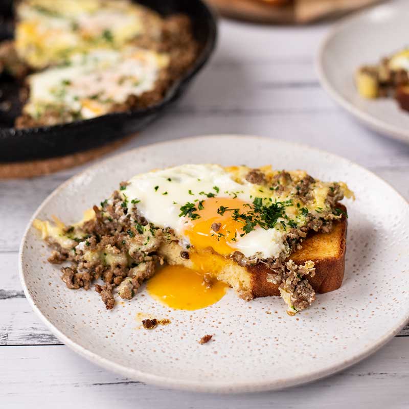 Keto Carnivore Baked Eggs on low carb bread with dripping egg yolk