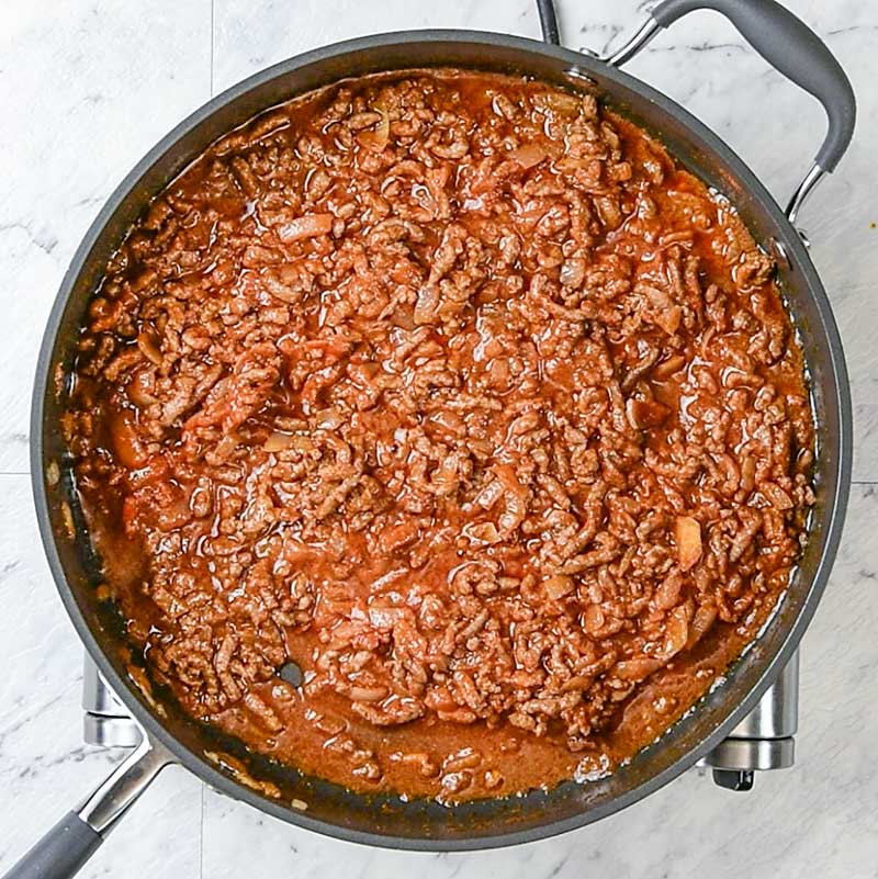 Chili Cheese Dog Casserole Ingredients in a frying pan