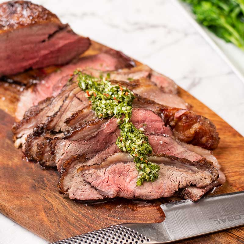 Keto Steak Picanha on a board with chimichurri sauce