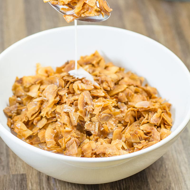 Keto corn flakes in a white bowl.