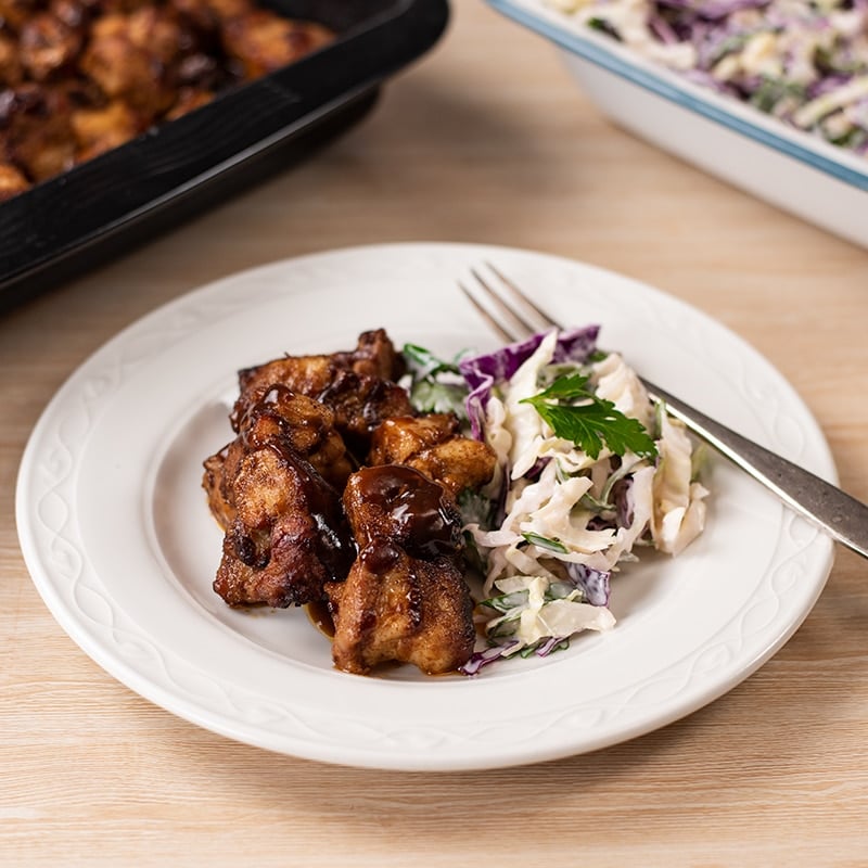 Keto BBQ Pork Belly Bites on a plate with coleslaw