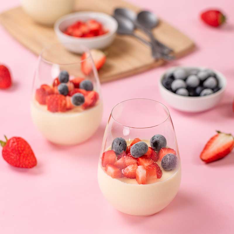 Keto Vanilla Panna Cotta in a glass on a pink table