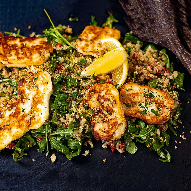 Keto halloumi salad on a black serving tray.