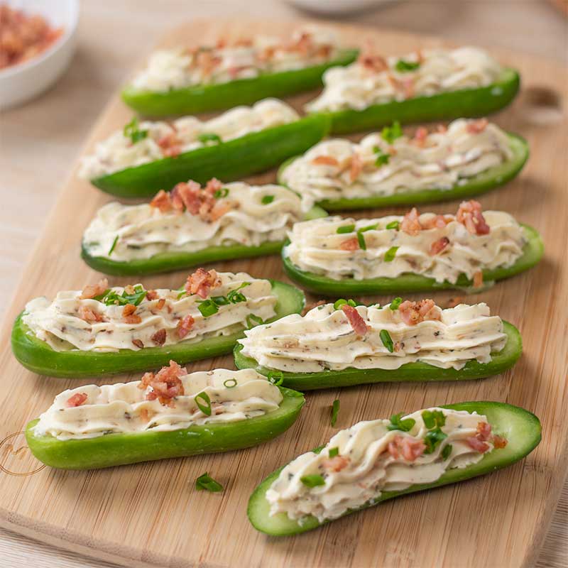 Keto Bacon Ranch Stuffed Cucumbers on a wooden board