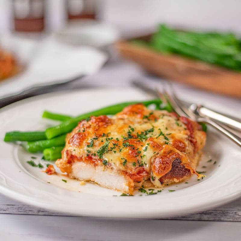 Keto Chicken Parmigiana on a plate with green beans