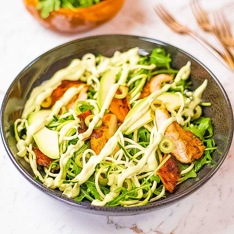 Keto chicken zoodle salad in a black bowl.