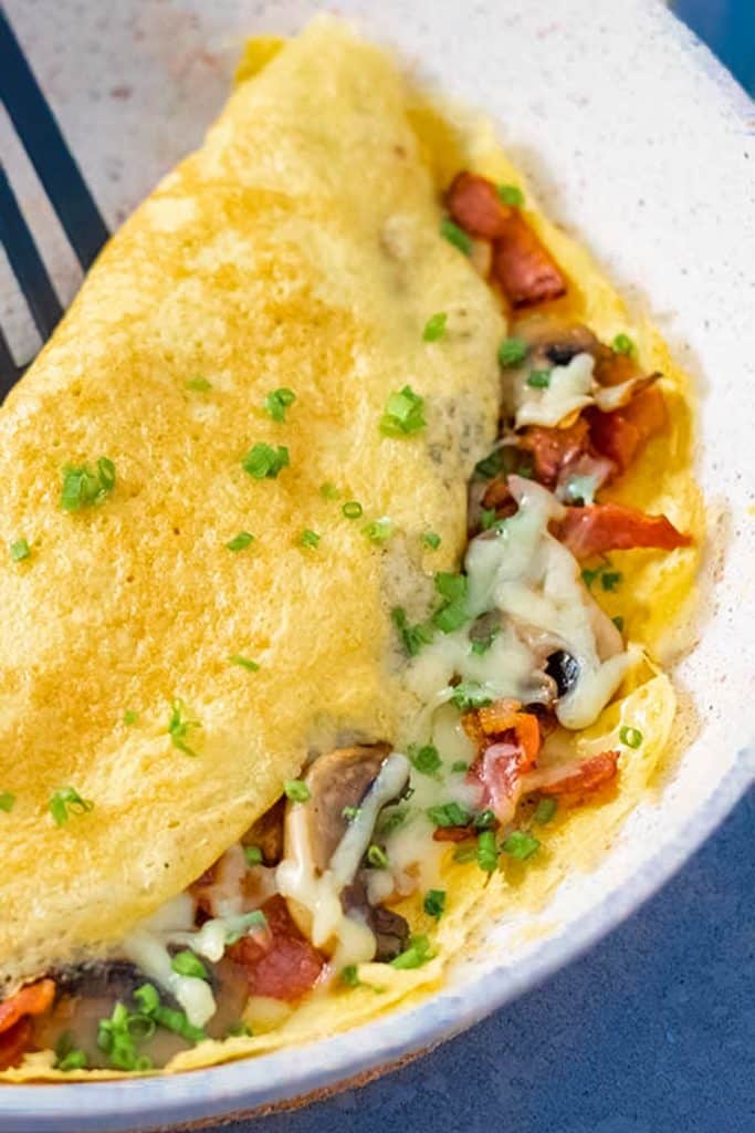 Keto omelet with bacon and mushroom on a plate.