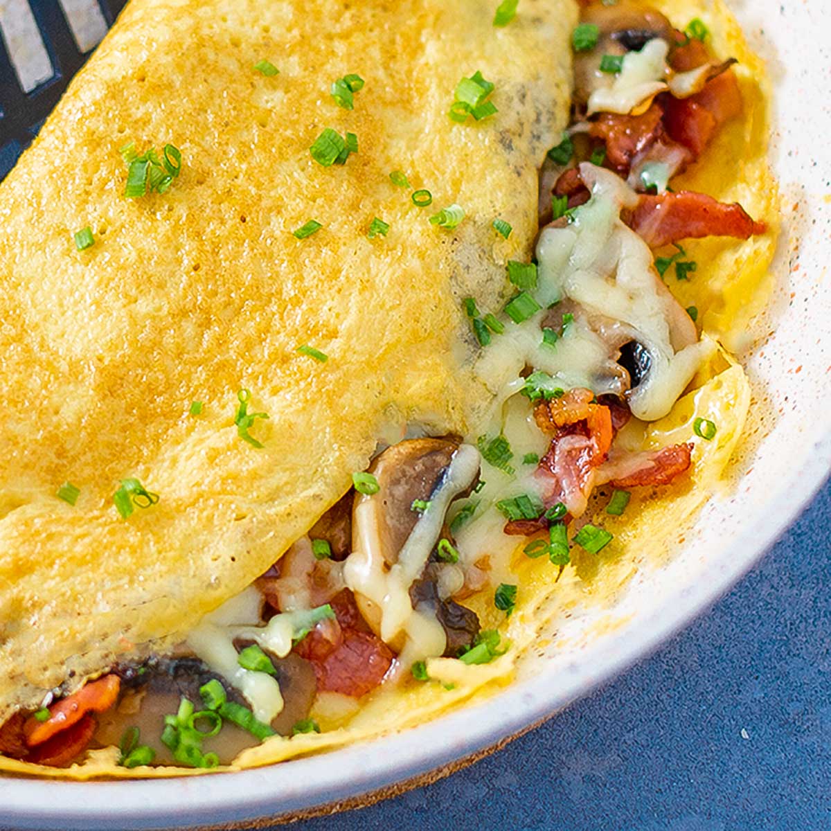 Bacon and mushroom keto omelette on a plate.