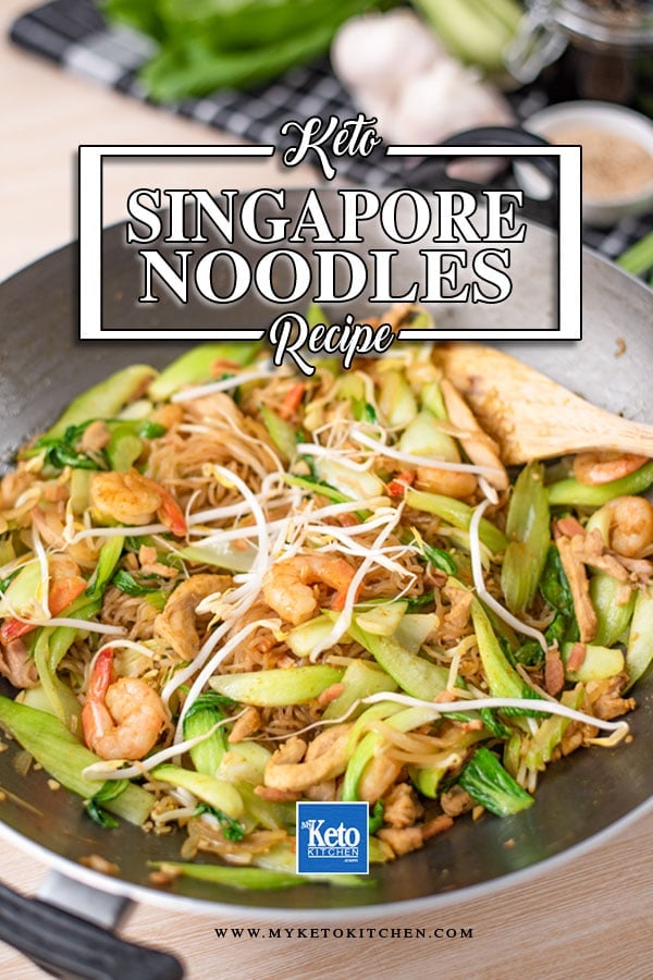 Keto Singapore Noodles in a wok with a wooden utensil tucked under the noodles on the right.