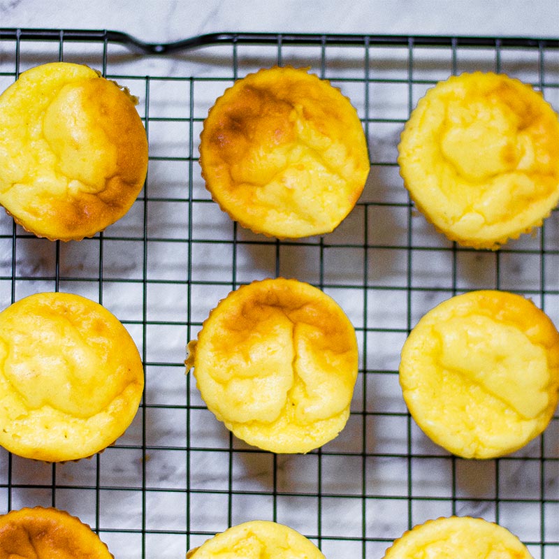 Keto vanilla muffins on a baking rack.