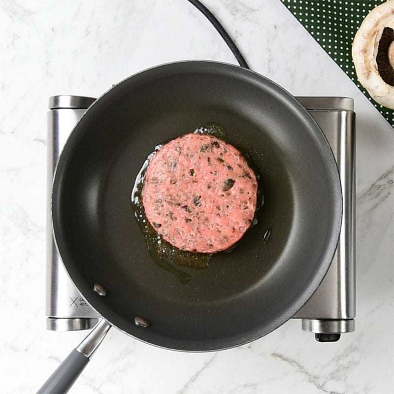 Keto Turkey Burger cooking in a frying pan