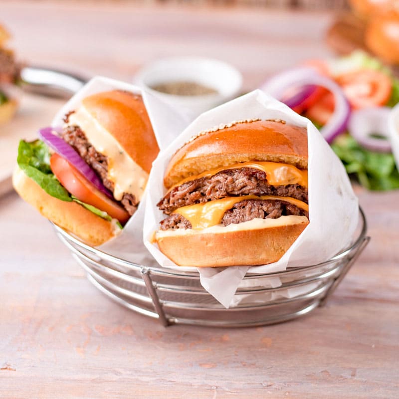 Two Keto Cheeseburgers in a stainless steel basket