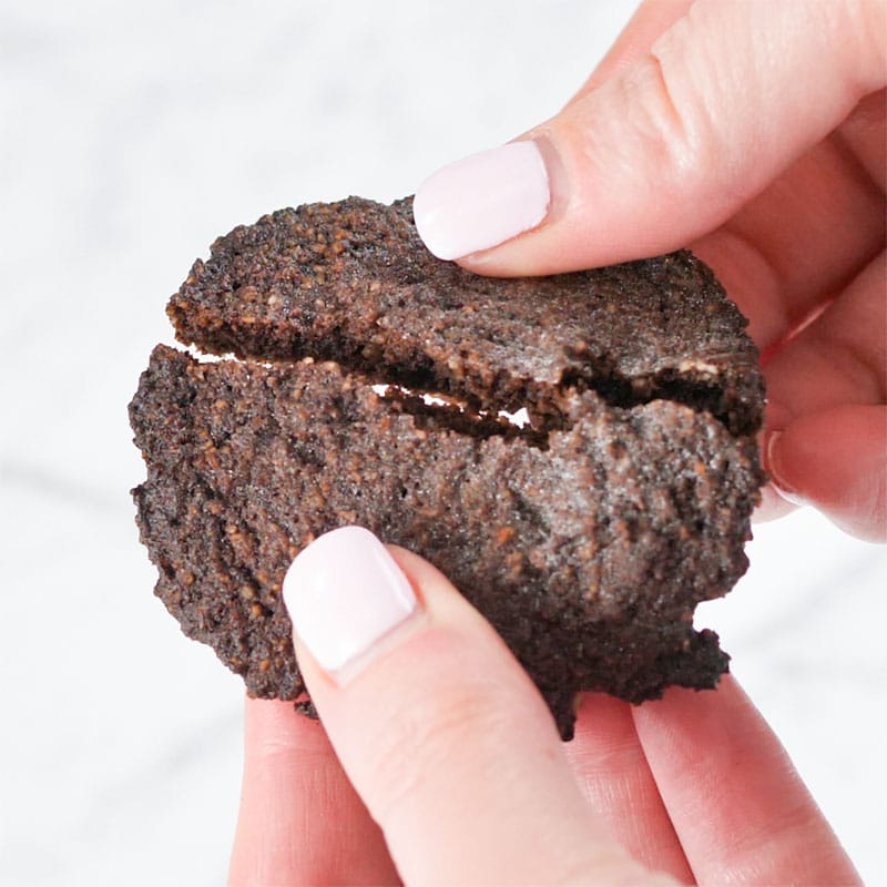 A Keto Chocolate Cookie being broken in half
