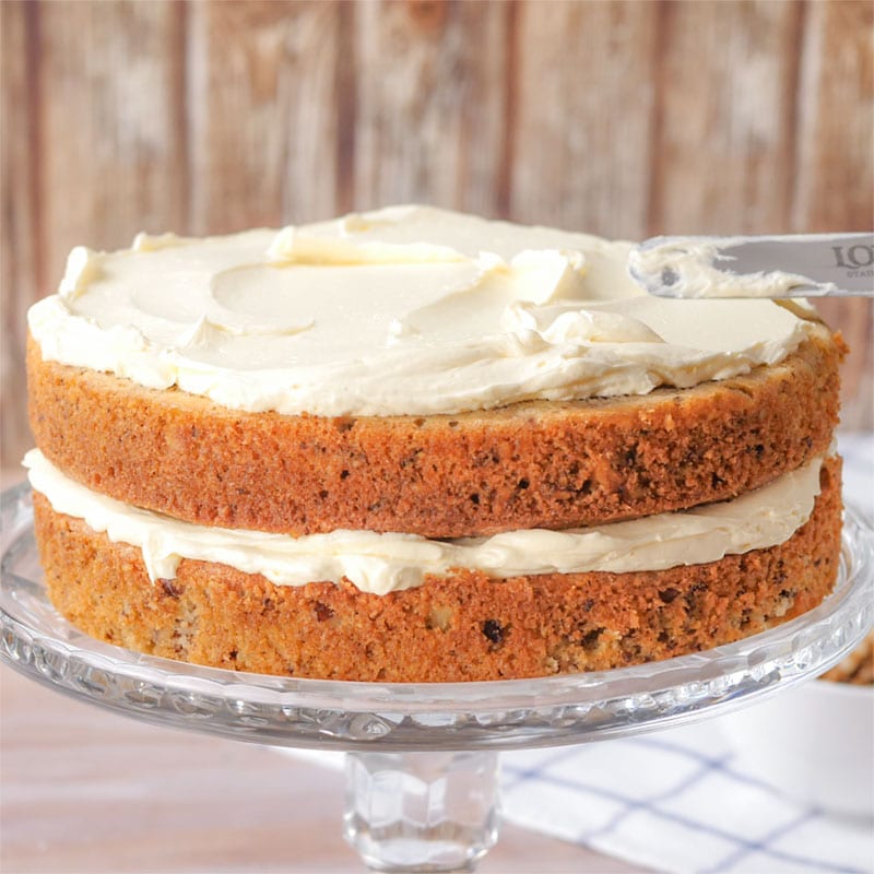 Keto Buttercream Icing being spread onto a Keto Walnut Cake