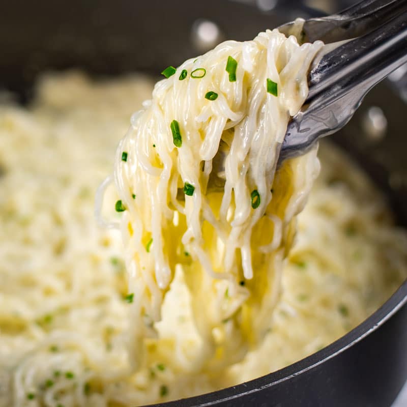 Keto Cheesy Pasta being lifted from the pan