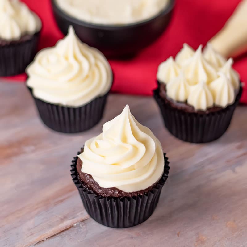 Keto Vanilla Buttercream piped onto chocolate cupcakes