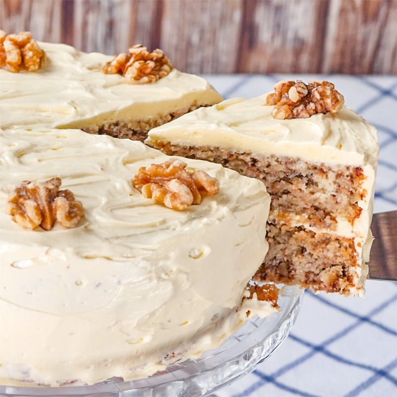 Keto Walnut Cake with a slice being removed from the side.