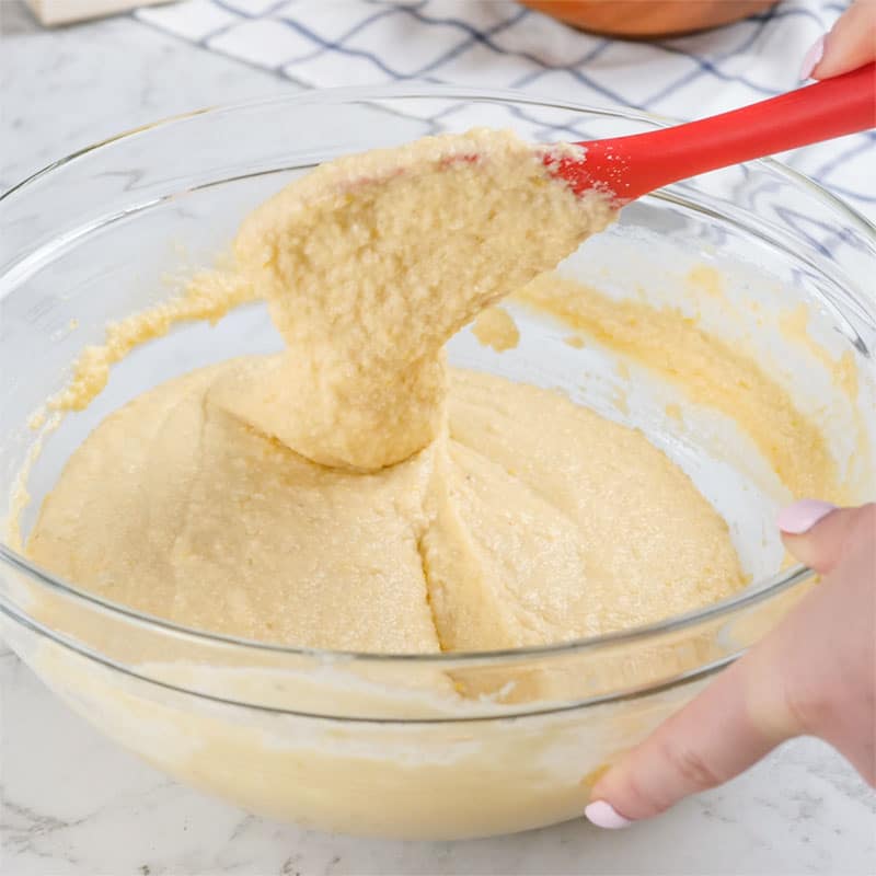 Keto Yogurt Cake Ingredients being mixed in a glass bowl.