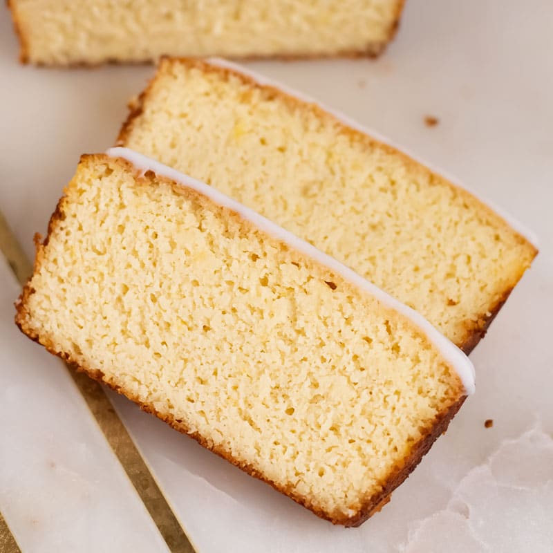 Two slices of Keto Yogurt Cake on a marble slab.