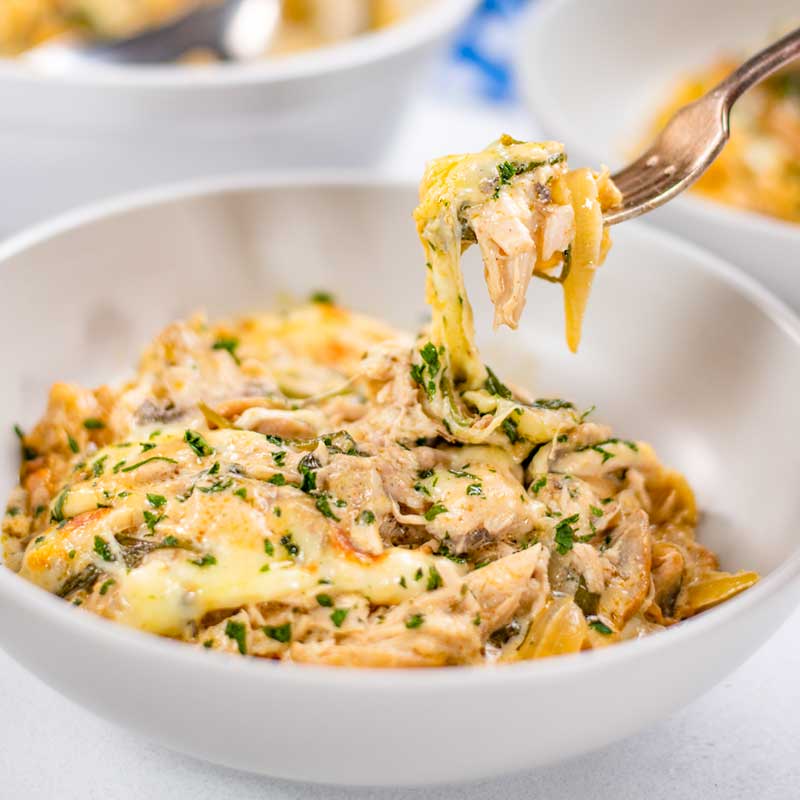 Chicken and Cheese Bake in a bowl with a forkful being removed.