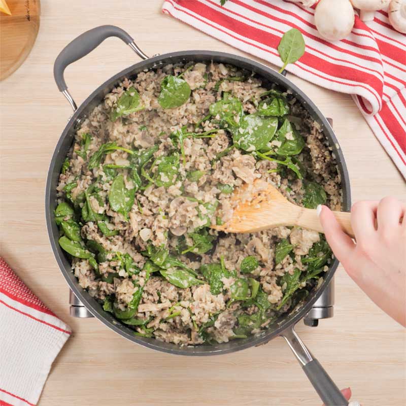 Keto Cheesy Ground Beef Casserole Ingredients being cooked in a frying pan.