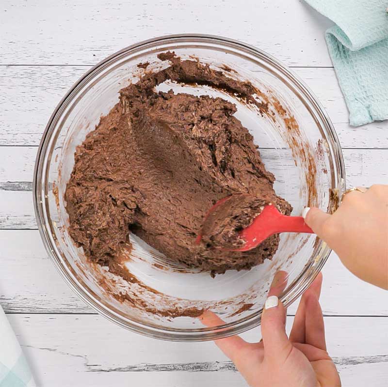 Keto Chocolate Banana Cake Recipe Ingredients being mixed in a bowl.