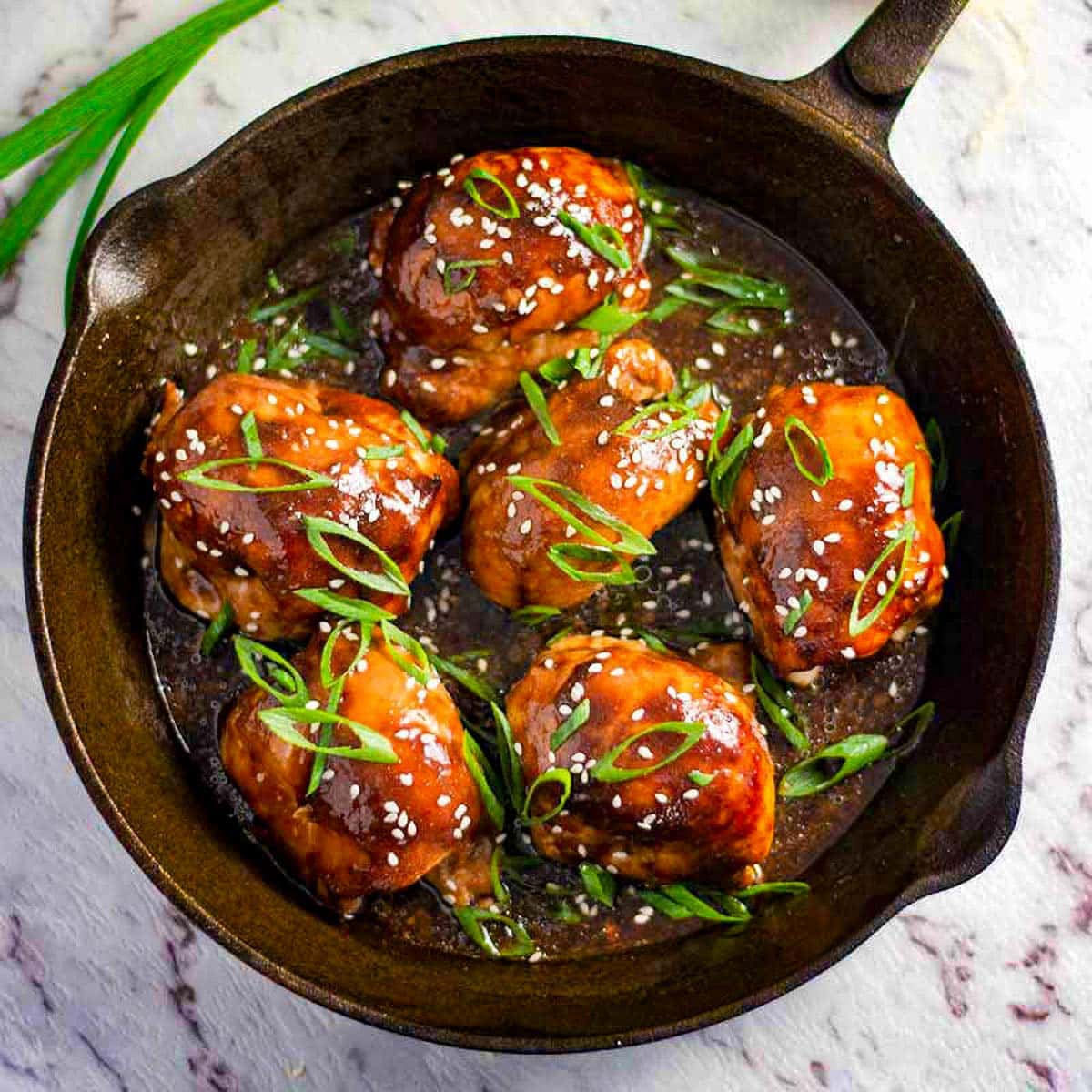 Keto teriyaki chicken in a cast iron pan.