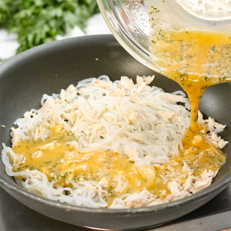 Keto Chicken Noodle Omelette Ingredients being pour into a frying pan.