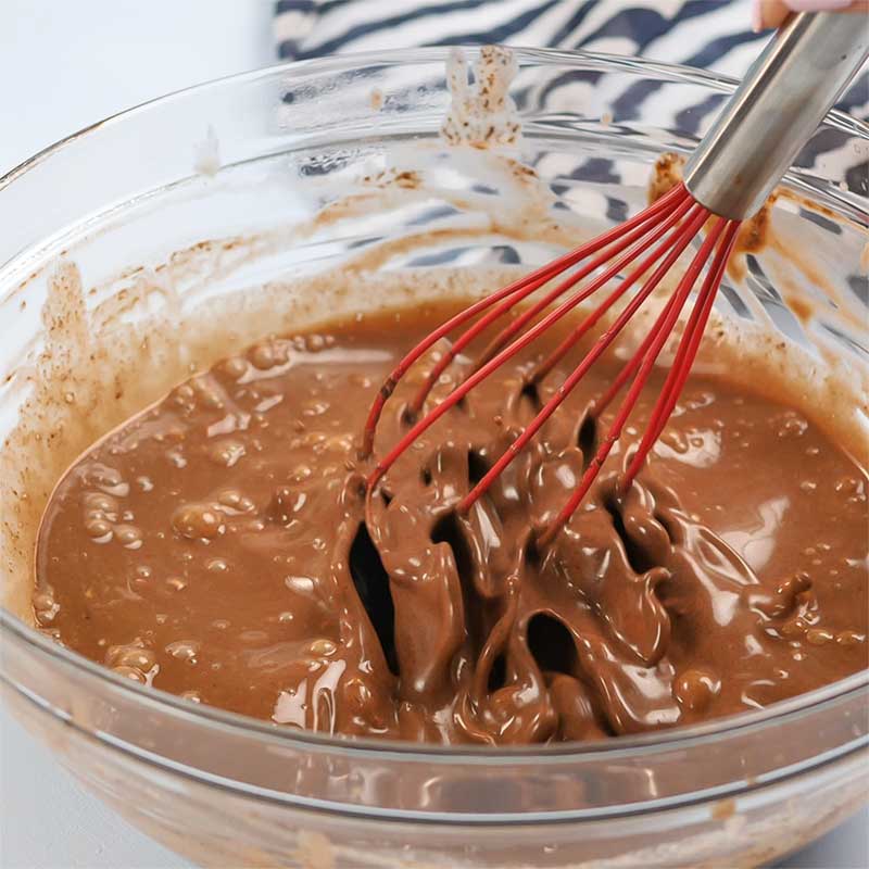 Keto Chocolate Ice Cream Bars Ingredients being whisked in a glass bowl.