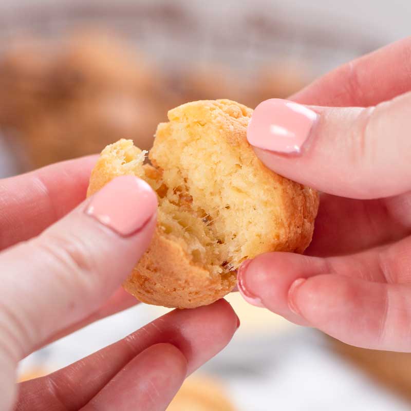 A Keto Brazilian Cheese Bread being torn in half.