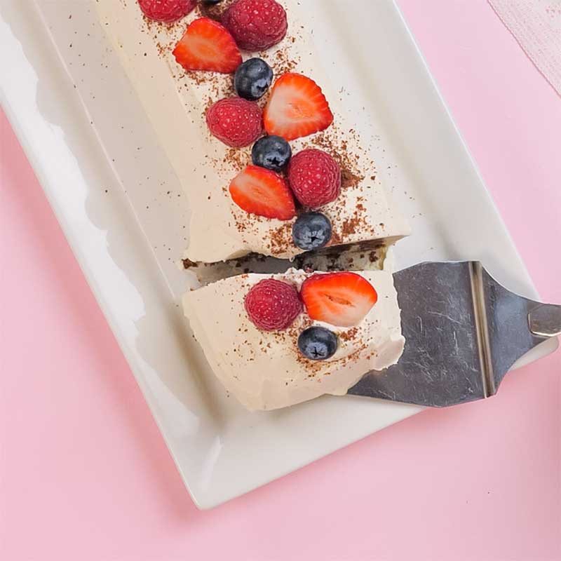 A cake lifter removing a slice of Keto Chocolate Ripple Cake.