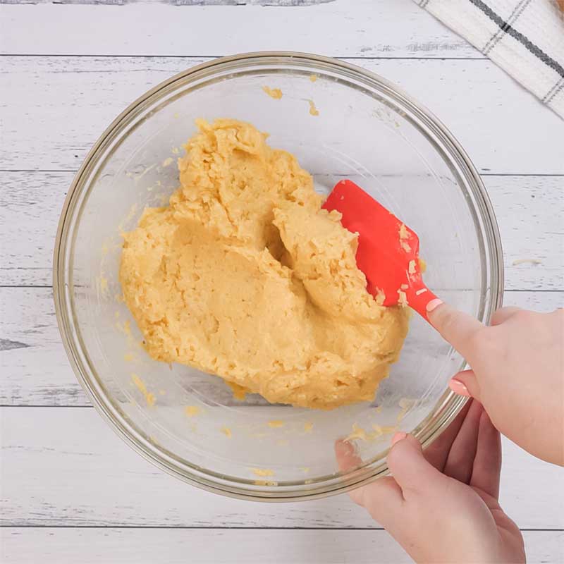 Keto Brazilian Cheese Bread Ingredients being mixed in a bowl.