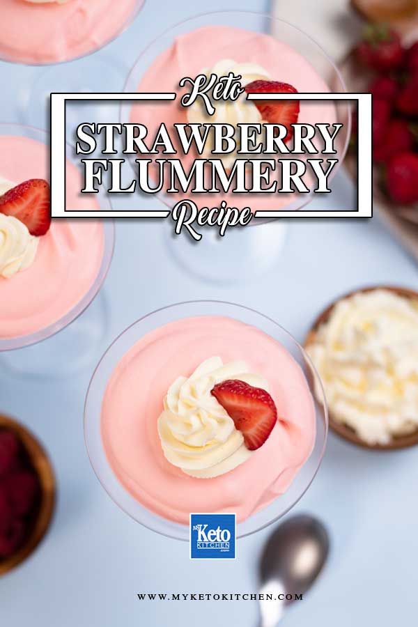 Keto Strawberry Flummery in martini glasses topped with whipped cream and strawberry slices.