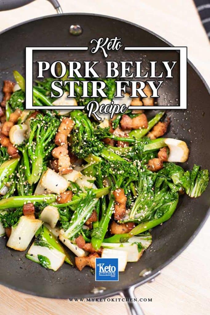 Pork belly stir fry in a wok with bok choy and broccolini.