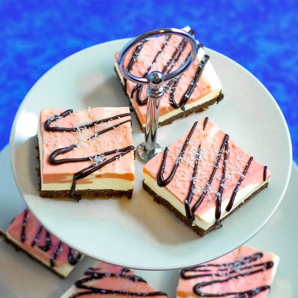 Cherry ripe slice on a tiered serving platter wit a blue background.