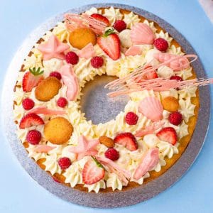 Low-carb cookie cake on a cake tray with a blue background.