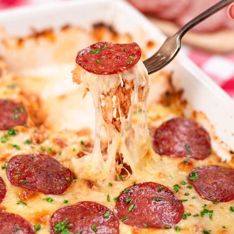 Keto Chicken Pizza Casserole being lifted from the dish with a fork.