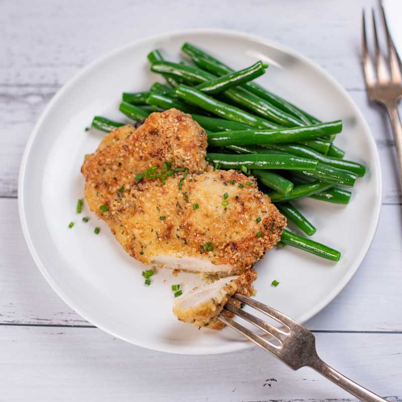 Keto Crispy Baked Ranch Chicken on a plate with green beans.