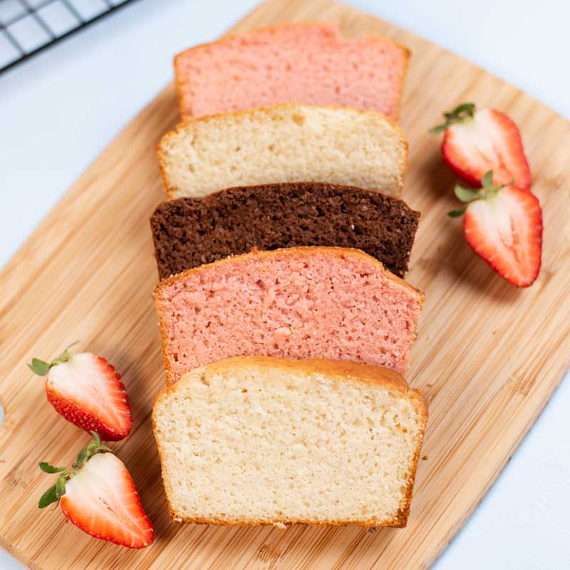 Keto Vanilla, Strawberry, and Chocolate Ice Cream Bread on a wooden board.