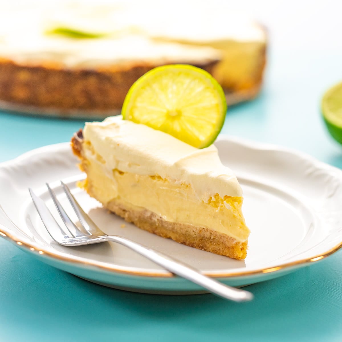 A slice of keto key lime pie on a white plate.