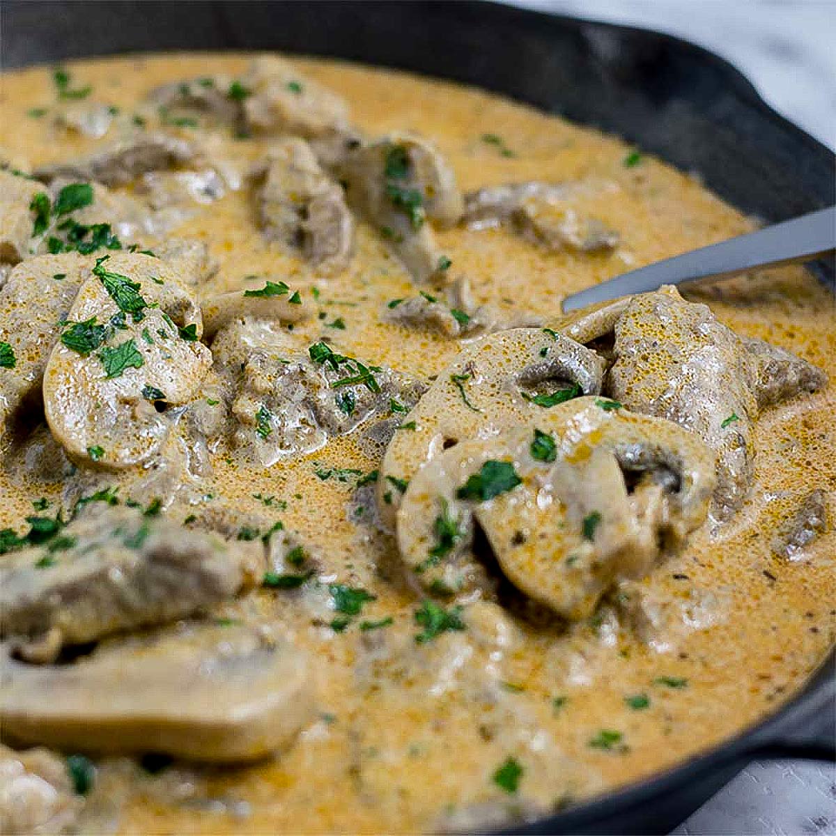 Keto beef stroganoff in a cast iron pan.