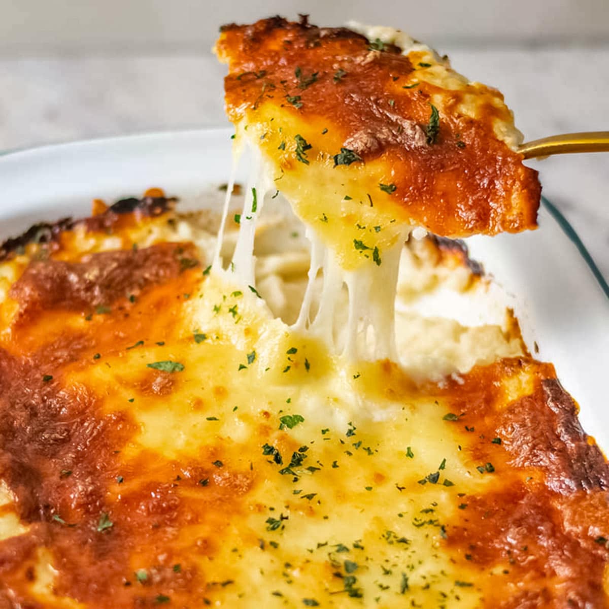 Cheesy cauliflower mash in a baking dish.