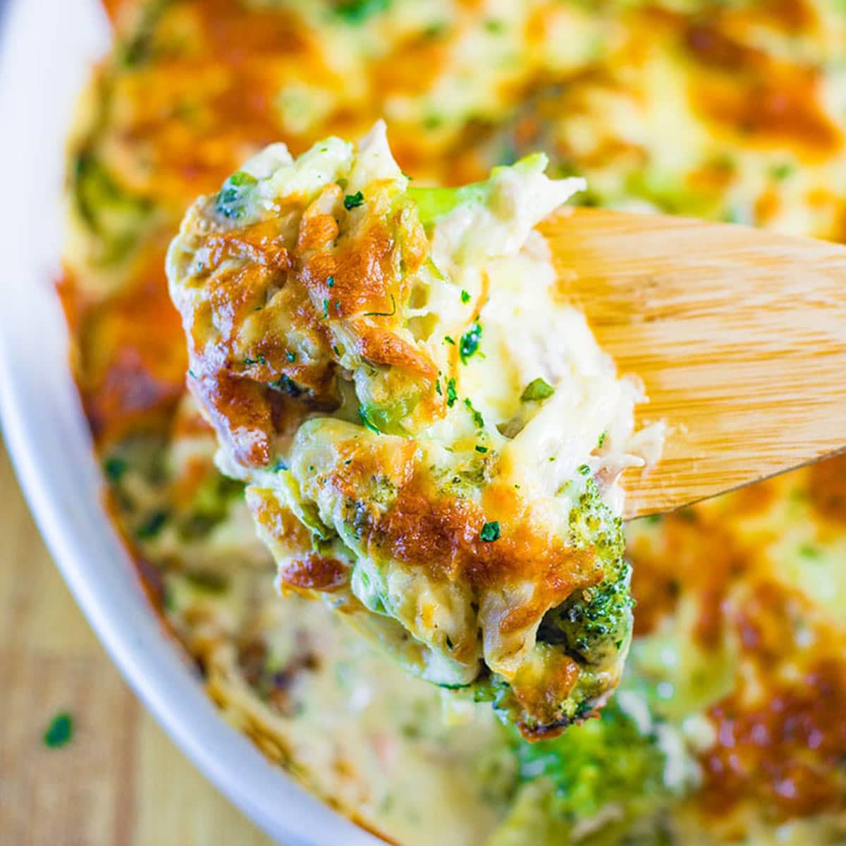 A spoon full of keto chicken, cheese and broccoli casserole bake.