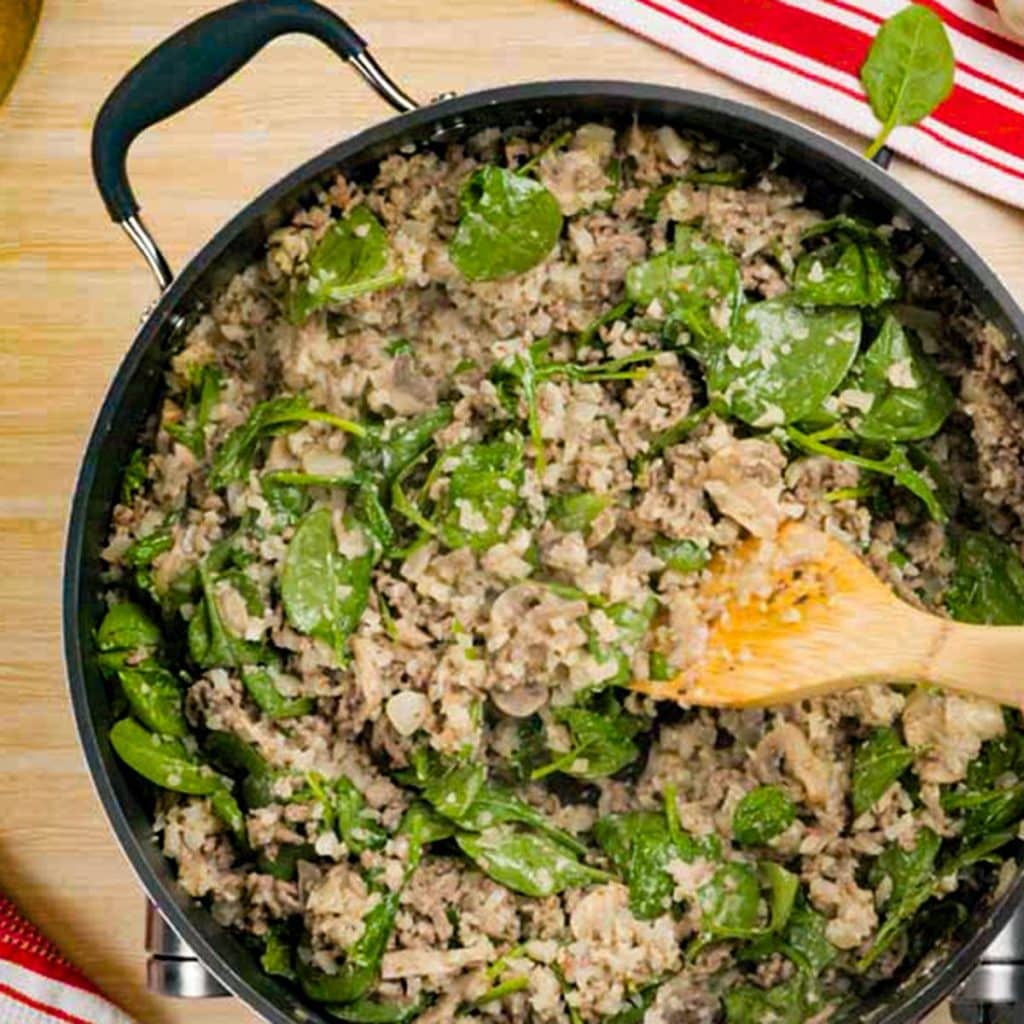 Keto ground beef and cheese casserole ingredients in a saucepan.