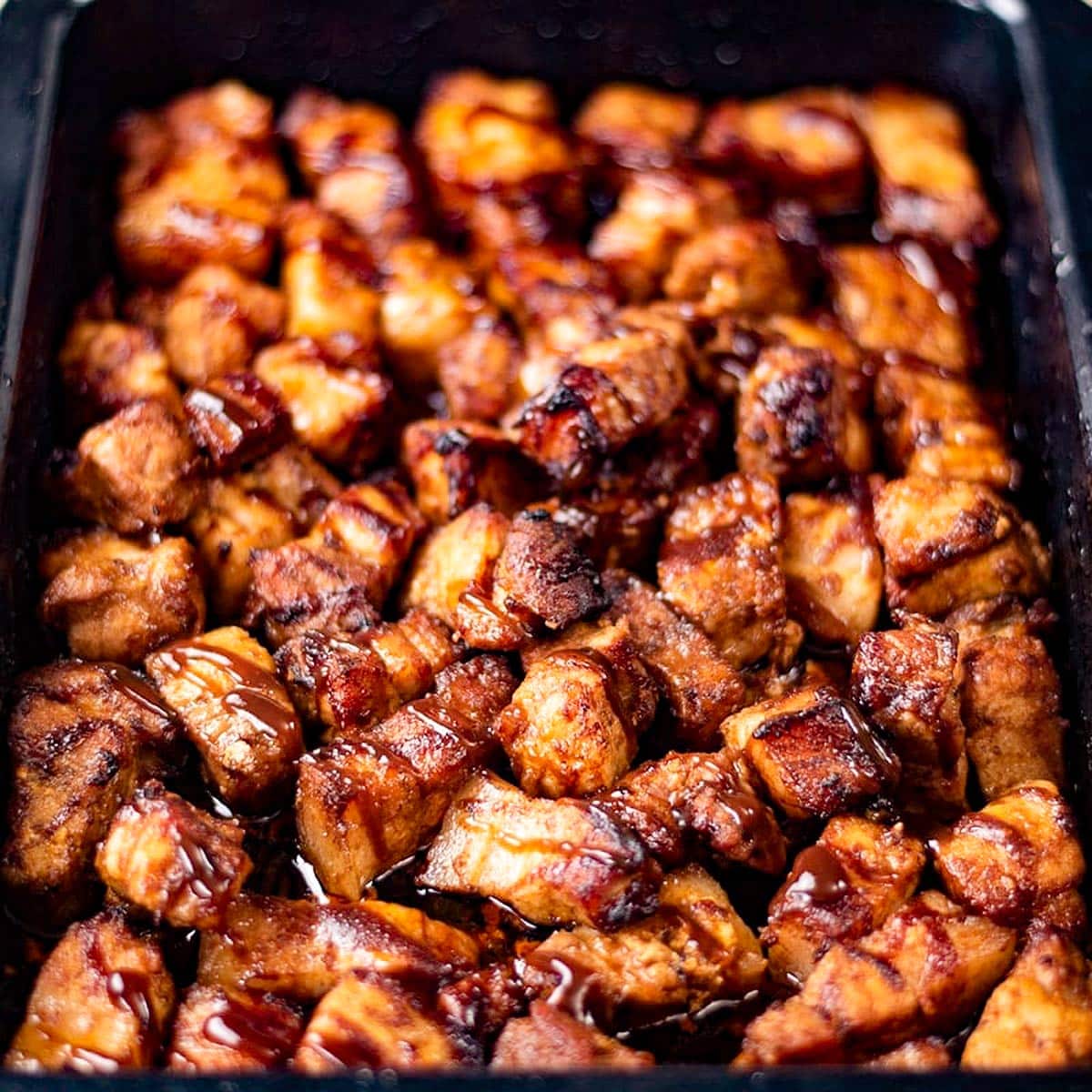 Keto pork belly bites in a baking tray.