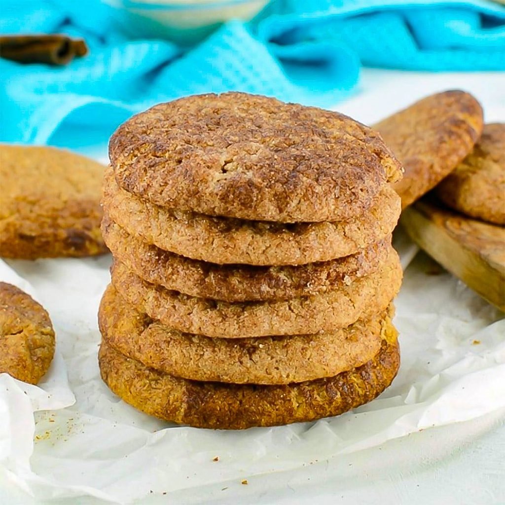 Keto Snickerdoodles stacked on baking paper.