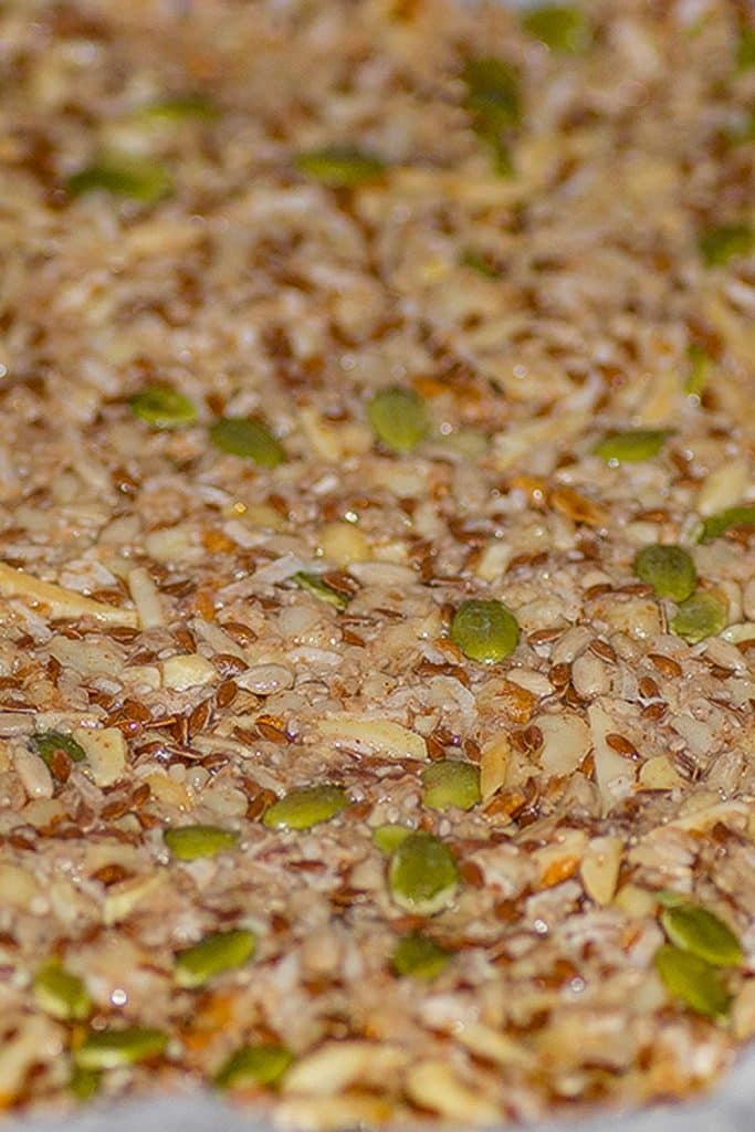 Keto granol bar ingredients on a baking tray ready to bake.