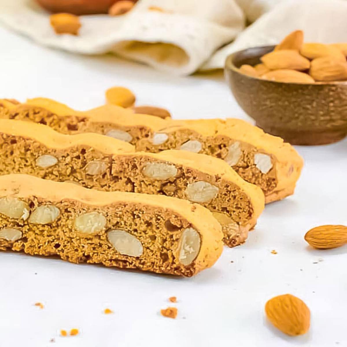 Three keto biscotti pieces on a plate.