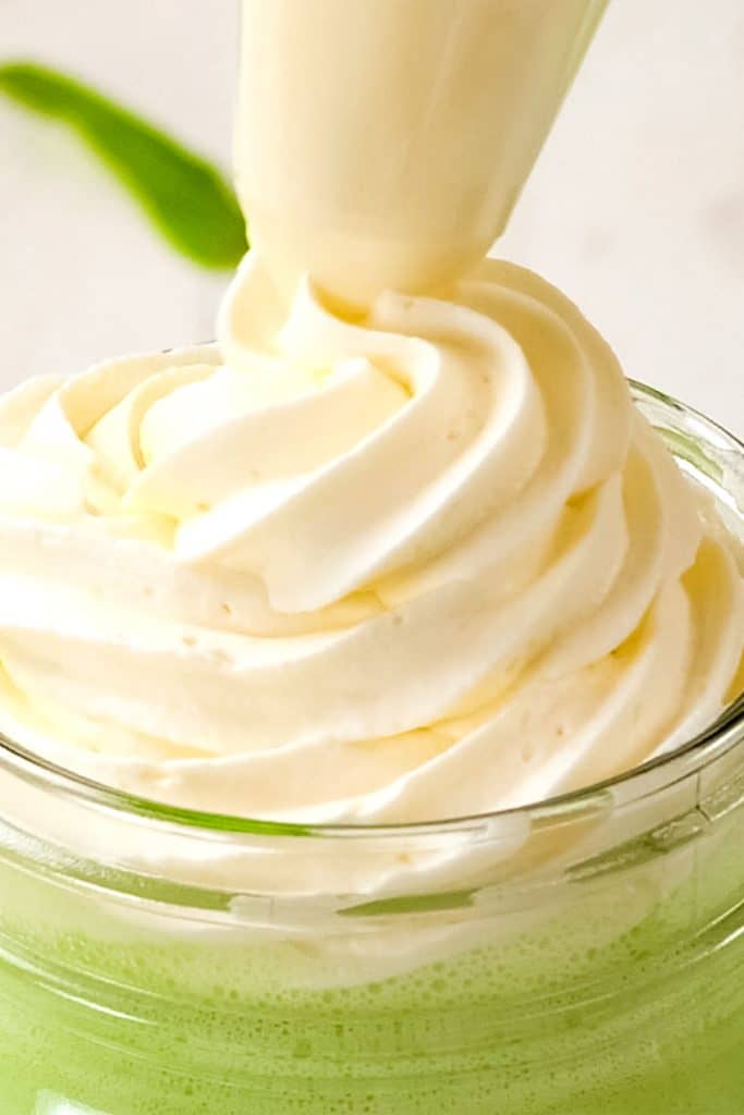 Keto whipped cream topping a green low-carb shake.