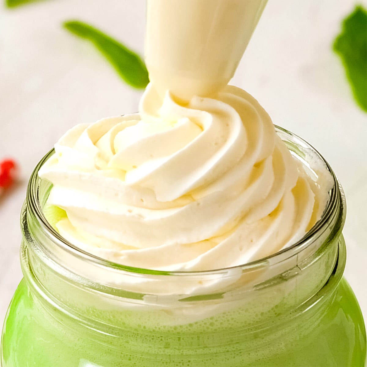 Keto whipped cream topping a smoothie.